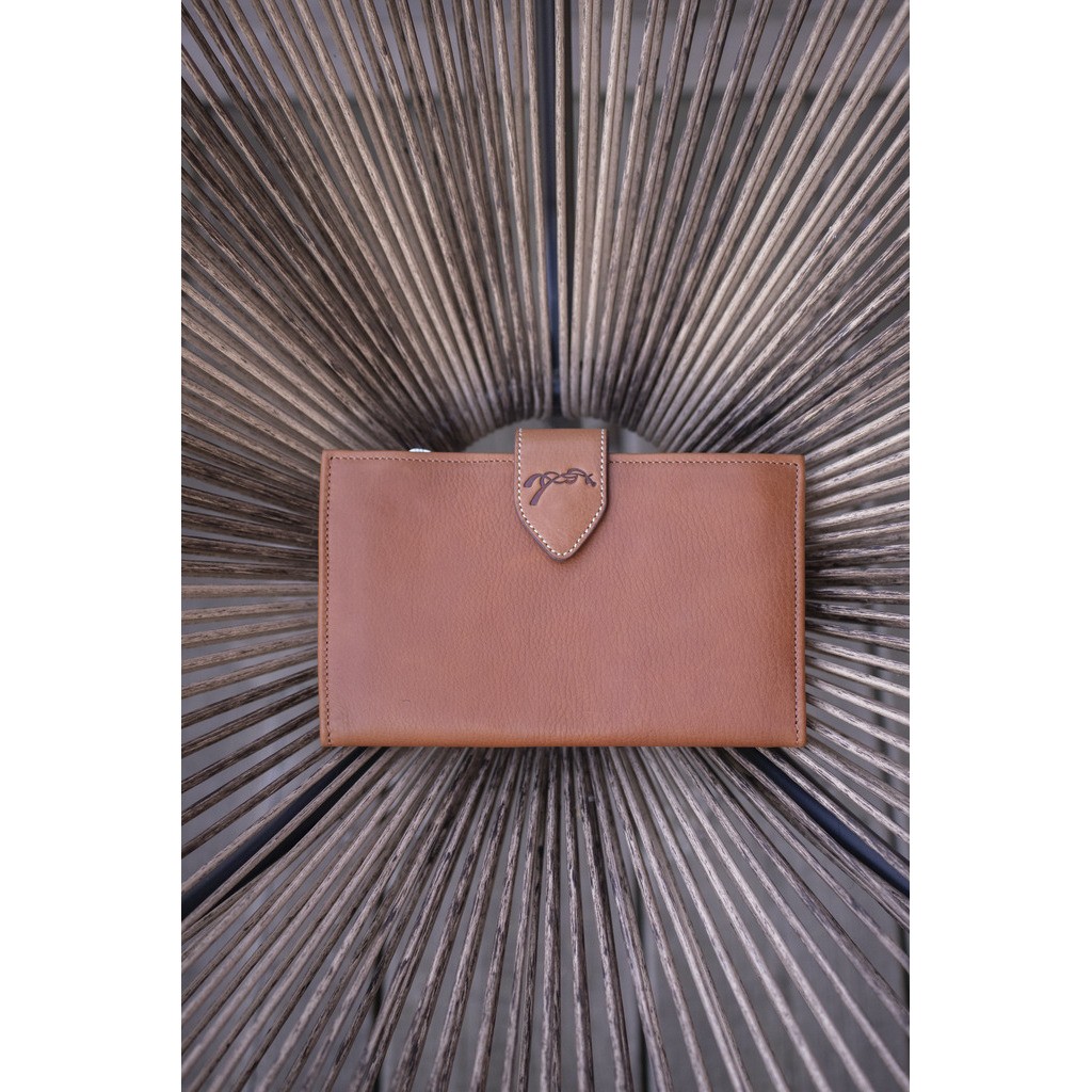 Brown leather portfolio with a sleek design, featuring a distinctive clasp and subtle stitching, set against a textured background.