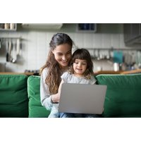 Online Maths Learning System for 5 users, featuring a smiling woman and child using a laptop on a green sofa.