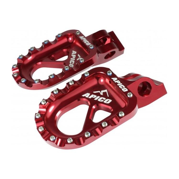 Red CNC machined aluminum foot pegs for trials bikes, featuring a textured surface for grip and a distinctive cut-out design, with the "APICO" logo prominently displayed.
