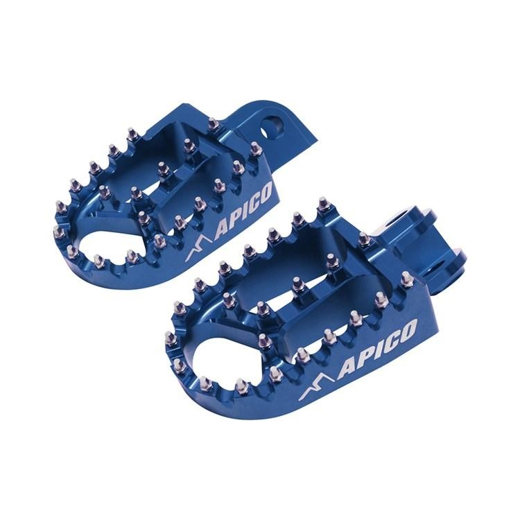 Blue aluminum foot pegs by Apico, featuring a textured surface and multiple grip pins, designed for Husqvarna TC 50/65 (2017-22) and FC/FE models (2014-16).