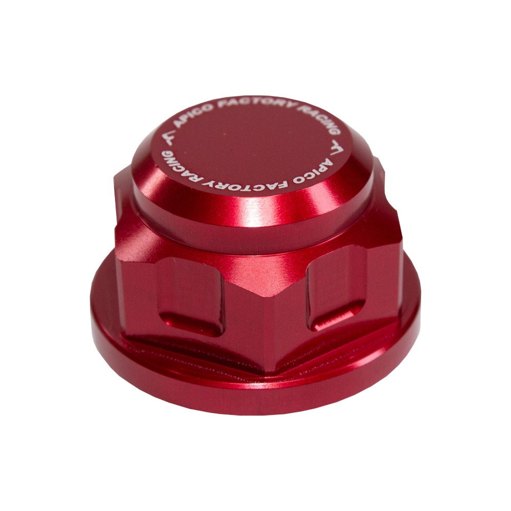 Red anodized aluminum axle nut with a hexagonal shape, featuring engraved branding and a smooth, polished finish, designed for various KTM and Husqvarna motorcycle models.