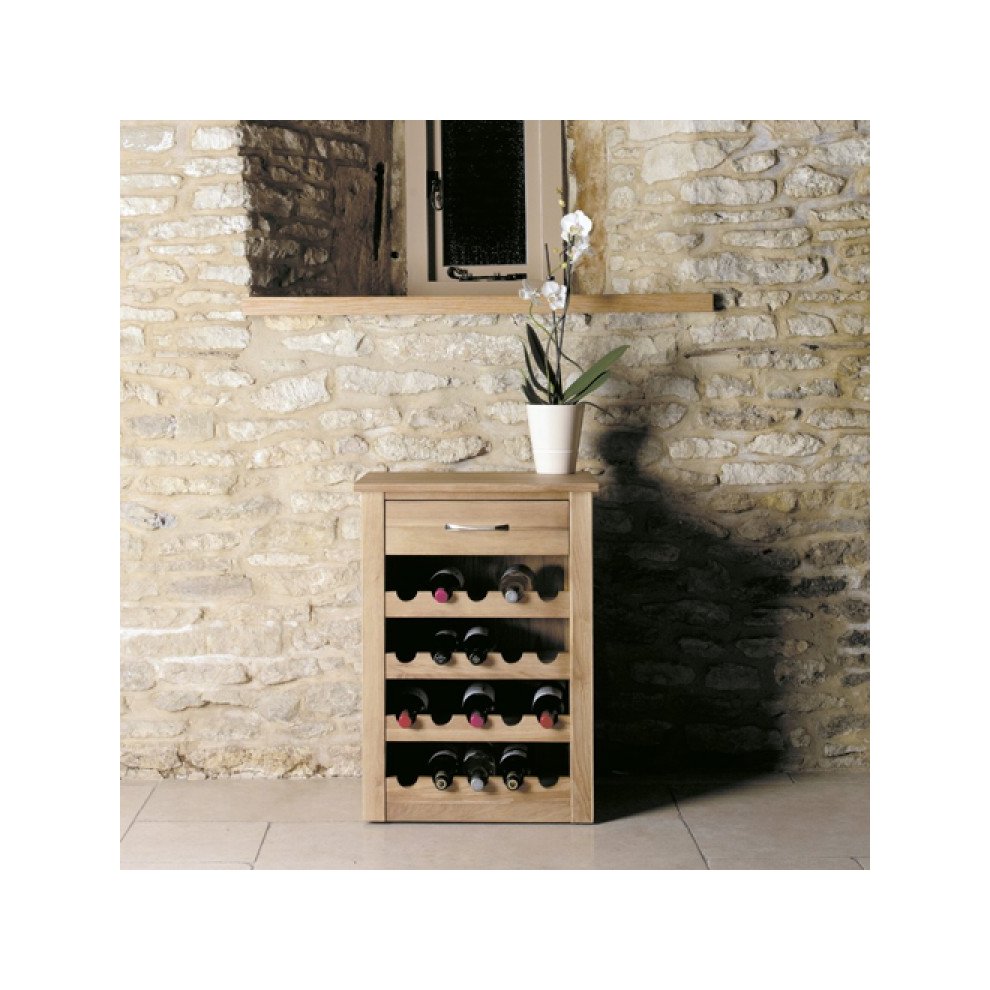 Brown oak wine rack lamp table featuring a drawer and space for multiple wine bottles, complemented by a potted plant on top, set against a stone wall.