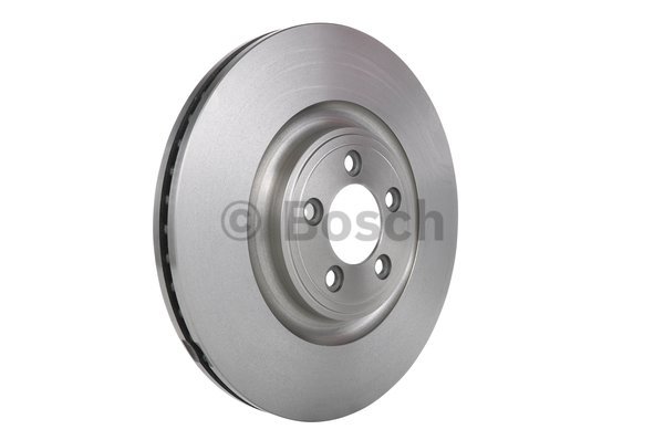 Vented brake disc featuring a silver metallic finish, circular shape, and multiple holes for mounting, designed for various Jaguar models by Bosch.