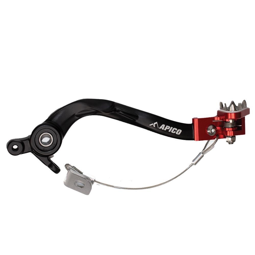 Black and red Apico brake pedal featuring a sturdy metal design, with a prominent logo, a serrated tip for grip, and a spring mechanism for enhanced performance on KTM and Husqvarna models.