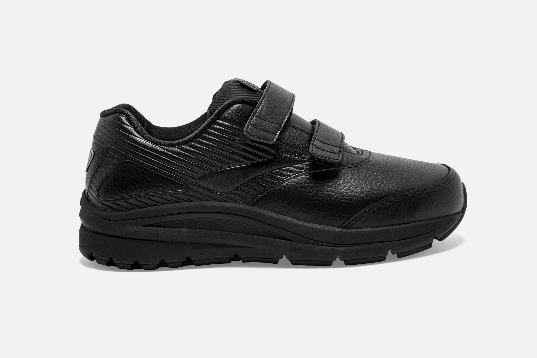 Black leather walking shoe featuring a V-strap closure, textured side panels, and a durable rubber sole for enhanced support and comfort.