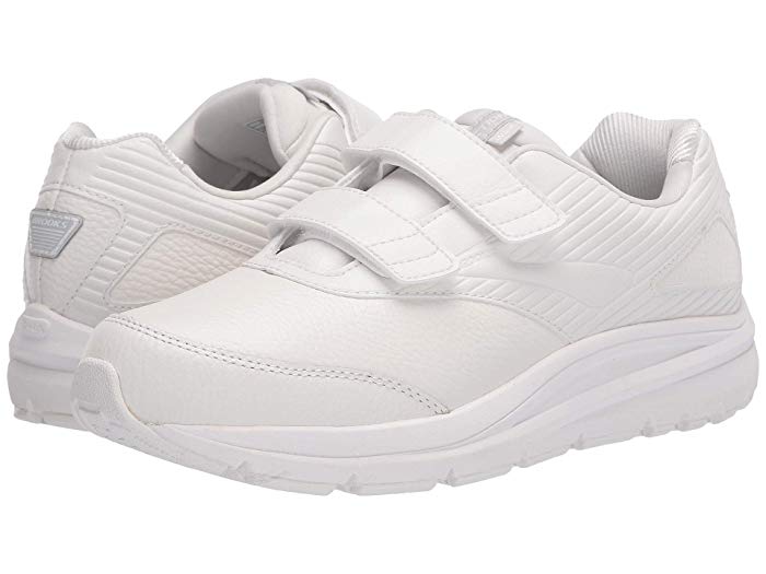 White leather walking shoes with a cushioned sole, featuring a V-strap design for easy wear, and a sleek, supportive silhouette, size 10.5 D.
