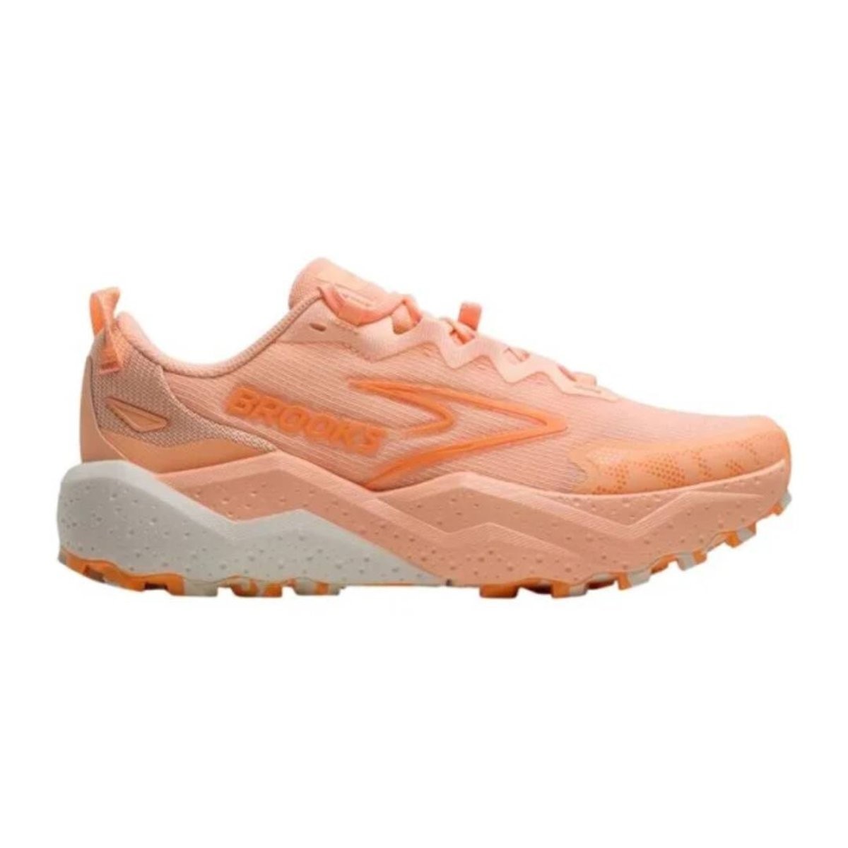 Light coral women's trail running shoes with a textured upper, featuring a prominent Brooks logo, cushioned sole, and rugged outsole for traction.