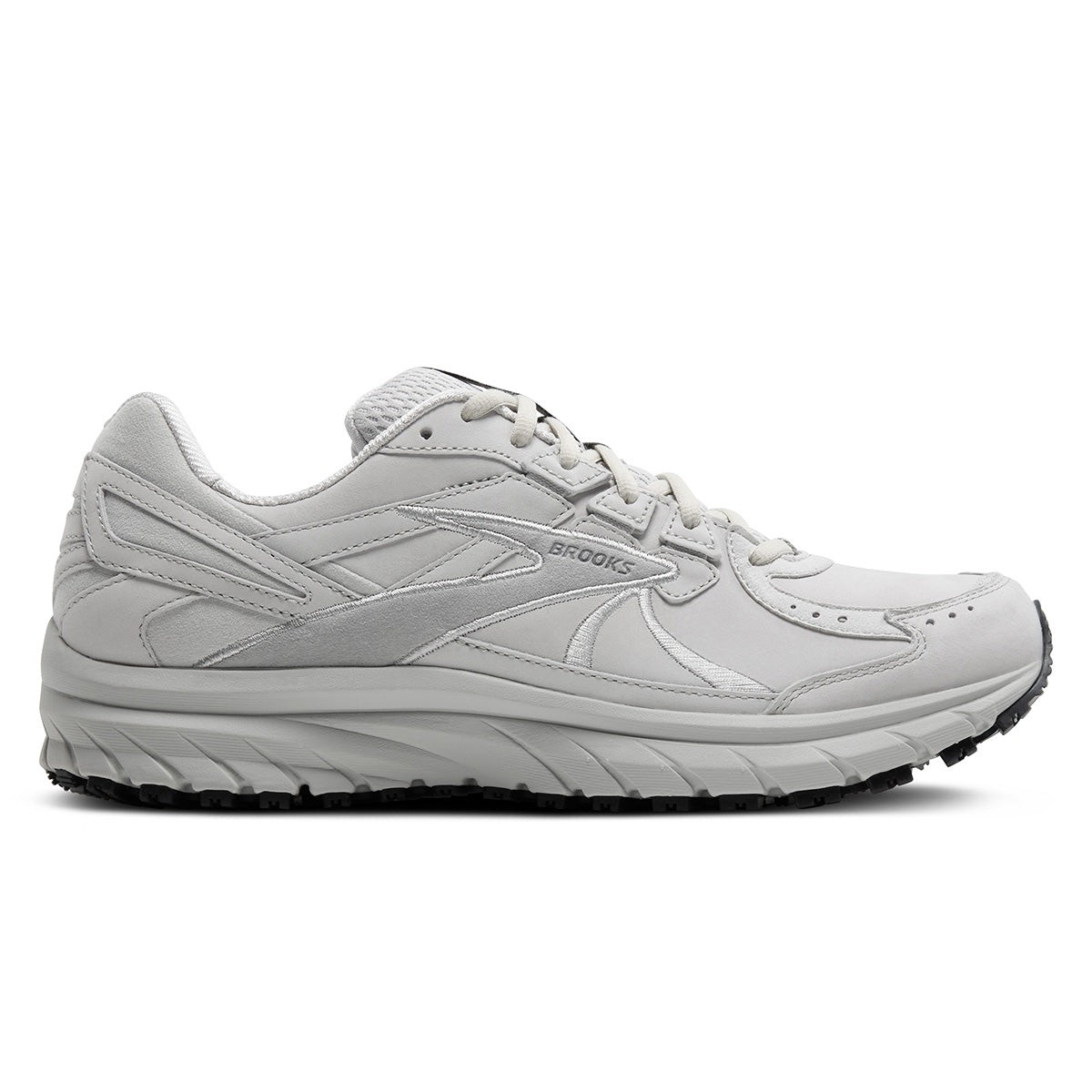 White leather running shoes with a cushioned sole, featuring a sleek design and subtle grey accents, ideal for walking and running.