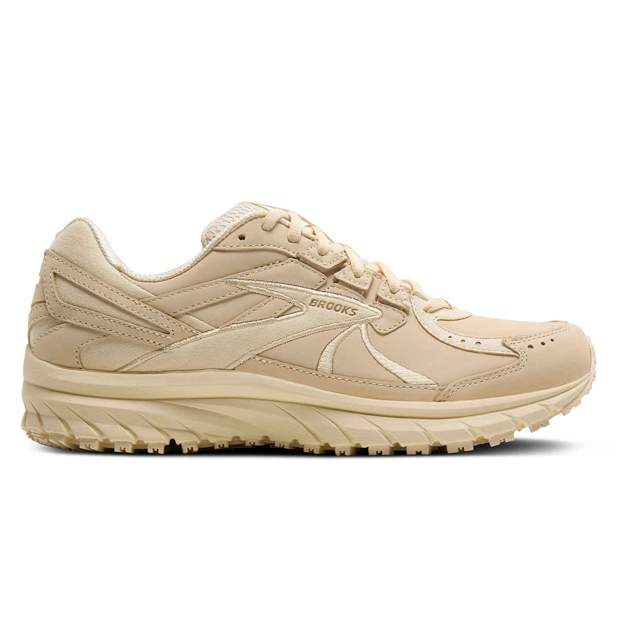 Light beige women's walking shoes with a cushioned sole, featuring a mix of smooth and textured leather, and the Brooks logo on the side.