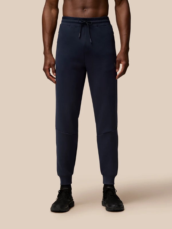 Blue polyester joggers with a tapered fit, elastic waistband, and side pockets, designed for men, featuring a sleek, sporty look.