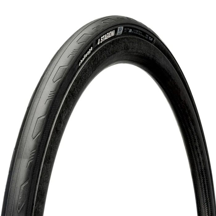 Black handmade road tyre with a textured surface and distinctive tread pattern, labeled "Challenge 4 Stagioni XP," size 700 x 35, designed for durability and performance.