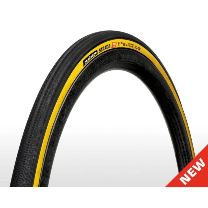Challenge Strada Pro Handmade Clincher Tyre in tan color, size 700 x 28, featuring a sleek black tread with a distinctive yellow stripe and textured surface for enhanced grip.