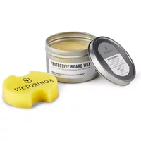 Victorinox cutting board wax in a silver tin with a yellow applicator sponge and black logo.