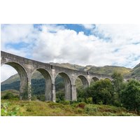 Tour package image featuring Glenfinnan Viaduct, a stone railway bridge with multiple arches set against a scenic landscape.