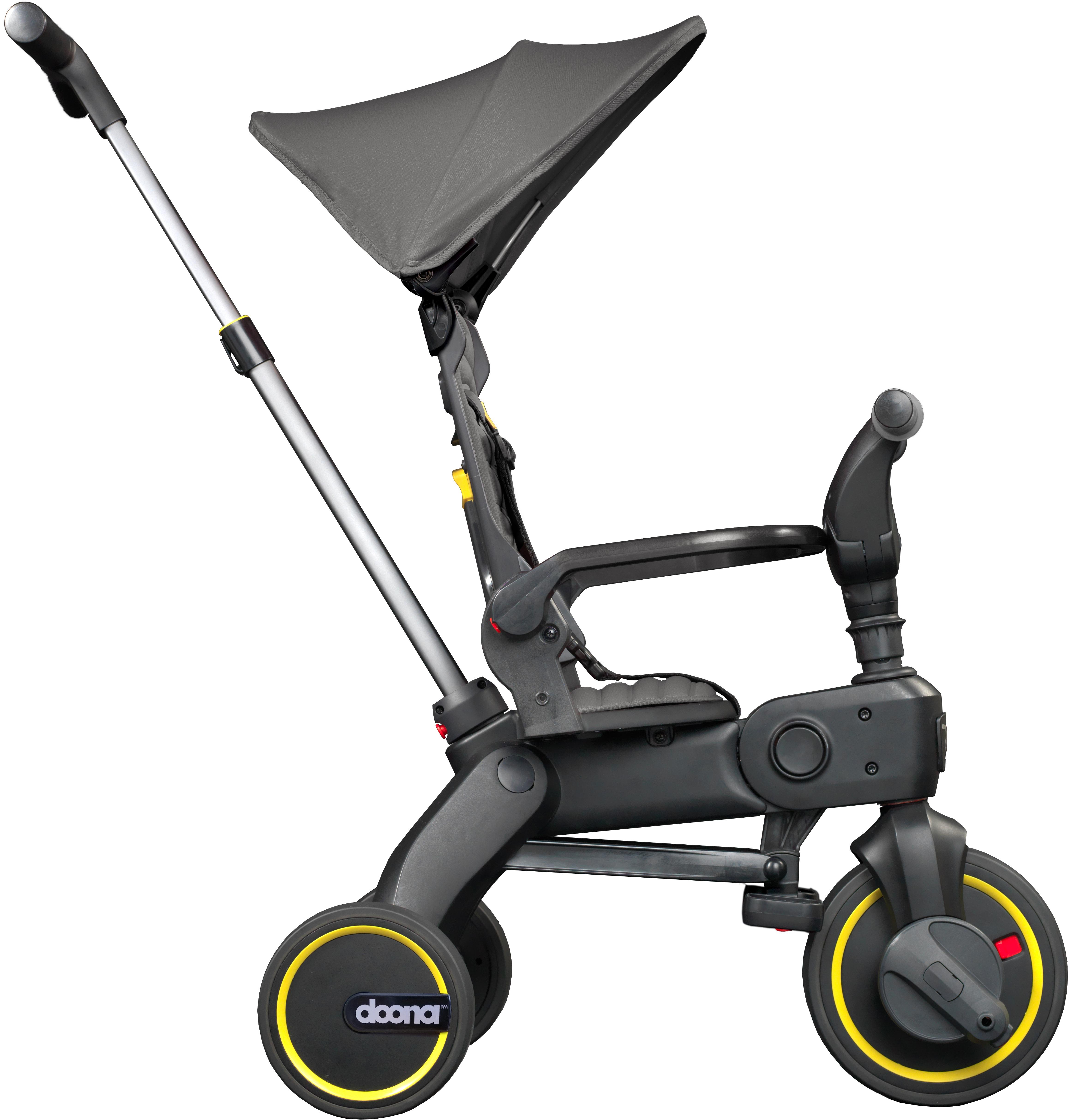 Grey Doona Liki Foldable Trike S1 with canopy, black seat, yellow-accented wheels, and adjustable push handle.