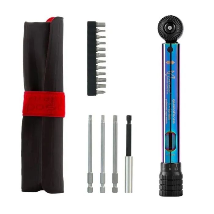 Colorful torque wrench with a rainbow finish, featuring a round adjustable dial, alongside a set of interchangeable bits and a compact carrying case.