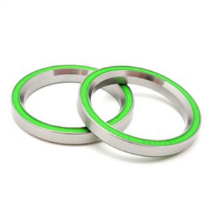 Two stainless steel ABEC sealed bearings with a green rubber seal, labeled S6901 2RS3, showcasing a smooth, polished finish and circular design.