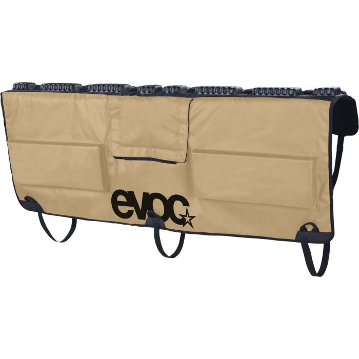 Sand-colored EVOC Tailgate Pad in medium/large size features multiple pockets, a durable material, and a prominent black logo, designed for secure bike transport.