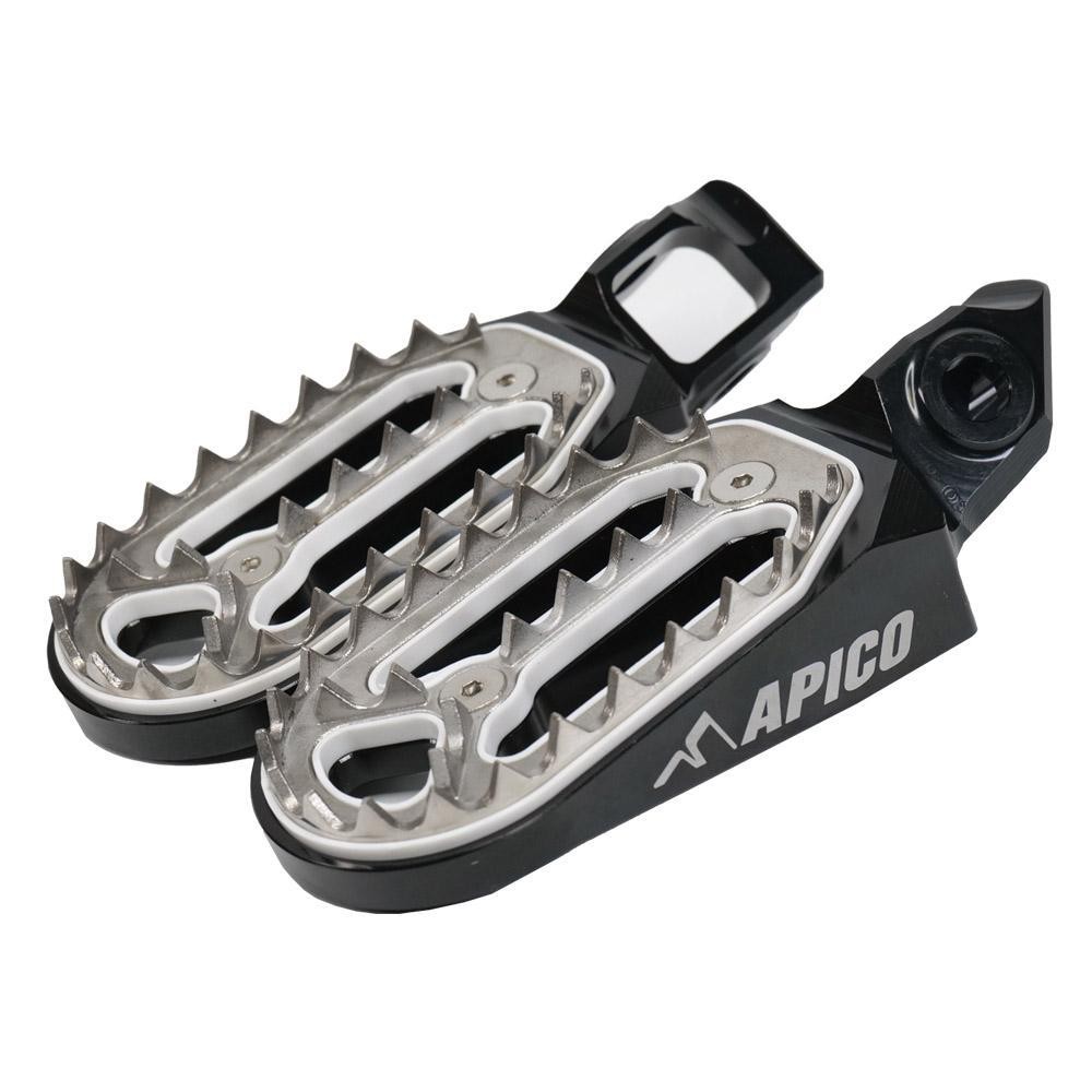 Black and silver Apico Pro Bite foot pegs featuring a rugged design with sharp teeth for grip, compatible with various KTM, Husqvarna, and Gas Gas models from 2023 to 2025.