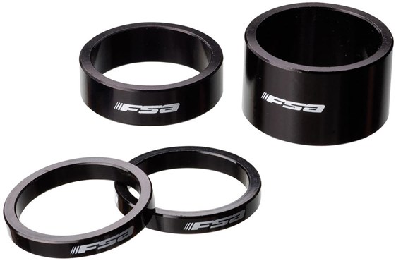 Black alloy headset spacers by FSA, featuring a smooth finish and engraved logo, includes one 10mm spacer and three additional rings in varying thicknesses.