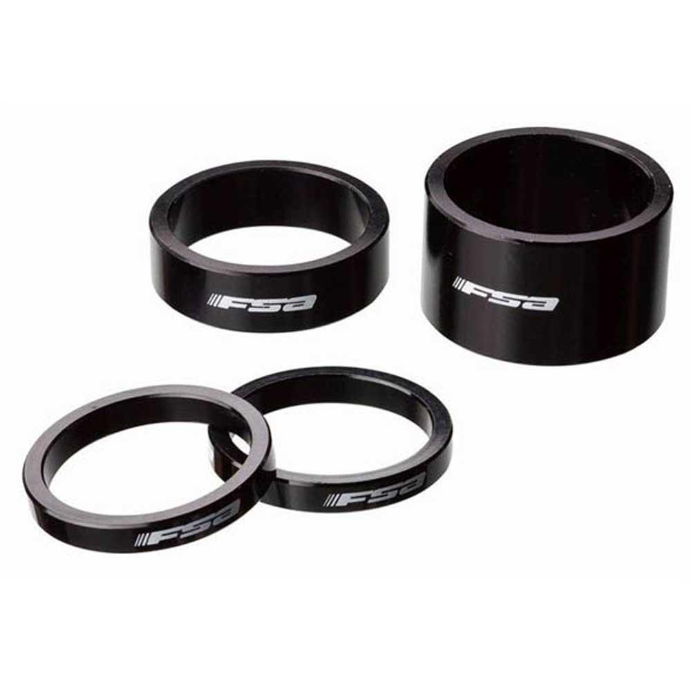 Black alloy headset spacers by FSA, featuring a sleek design with the FSA logo, includes one 3mm spacer and three additional rings of varying heights.