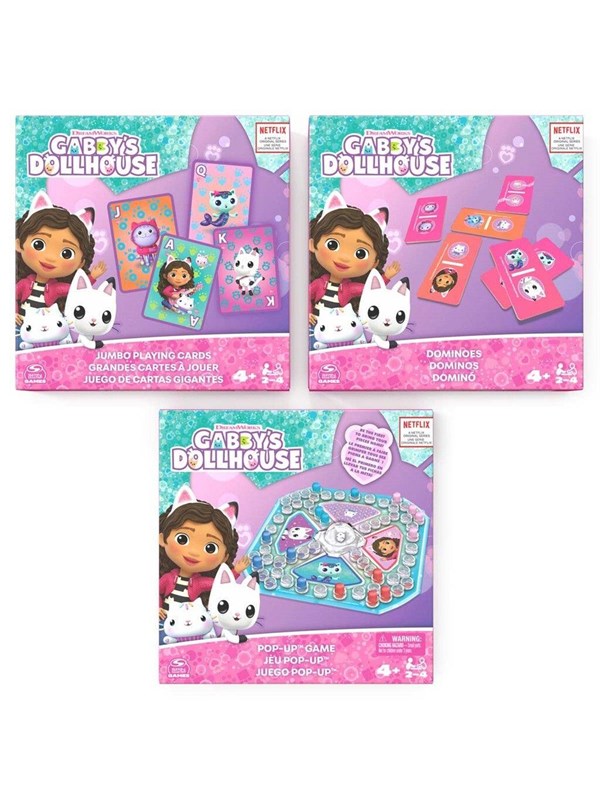 Three colorful game boxes featuring Gabby's Dollhouse characters, including a pop-up game, dominoes, and jumbo playing cards, all set against a vibrant blue and pink background.