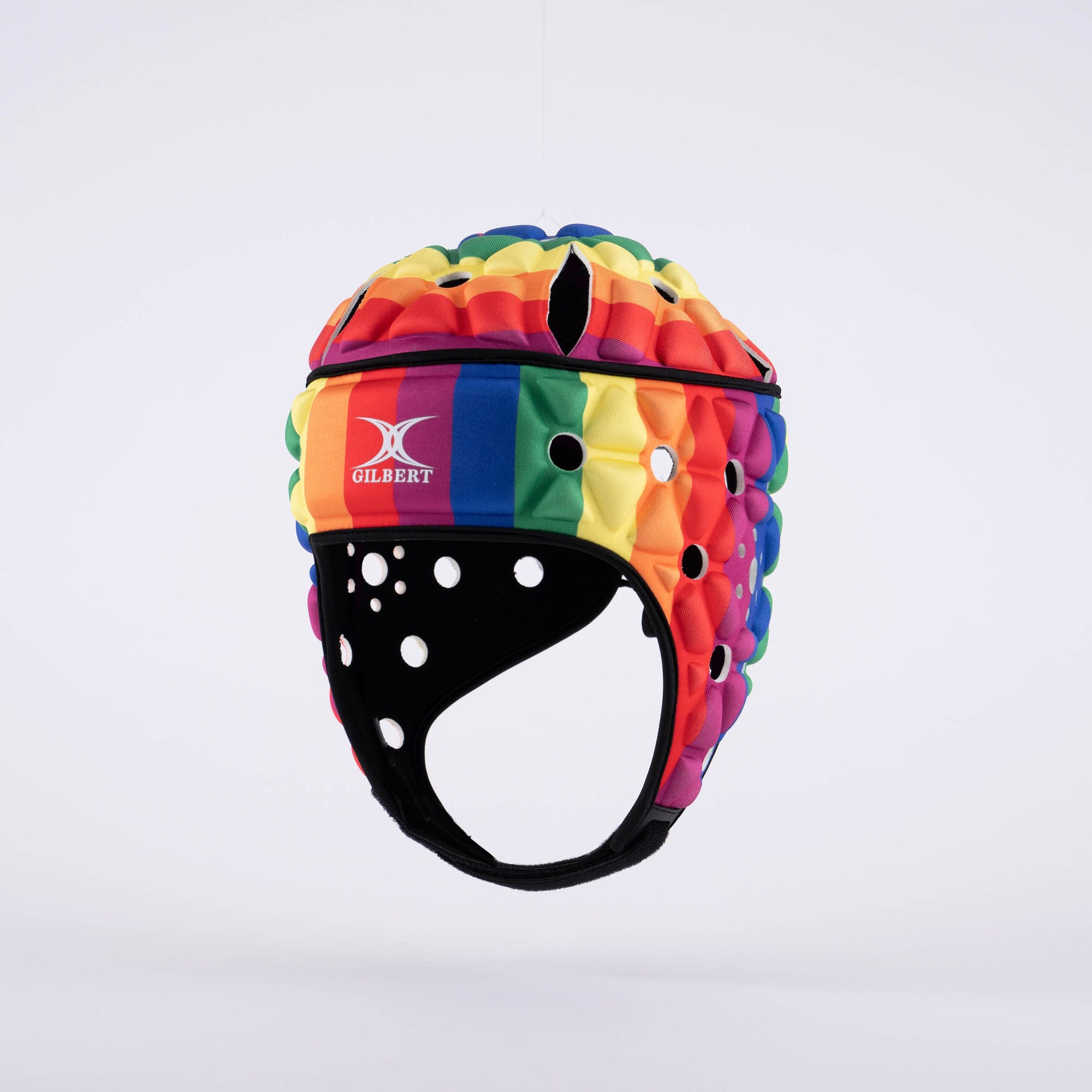 Colorful rainbow-patterned rugby headguard with a textured surface, featuring ventilation holes and a black chin strap, designed for safety and visibility on the field.