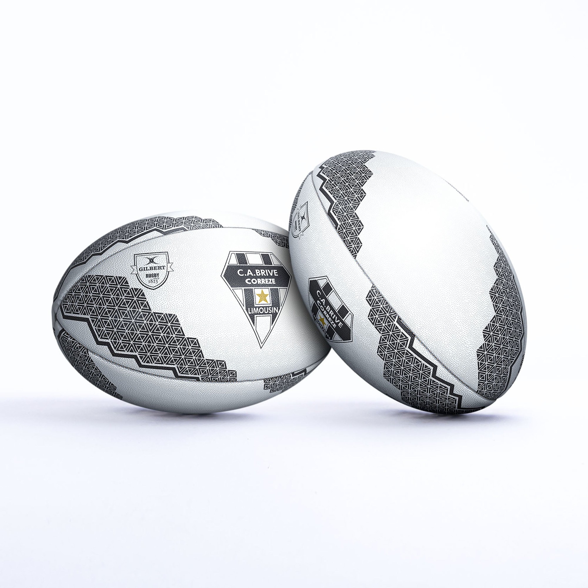 White rugby balls with black geometric patterns and the "C.A. Brive" logo, featuring a textured surface for grip and a sleek design.