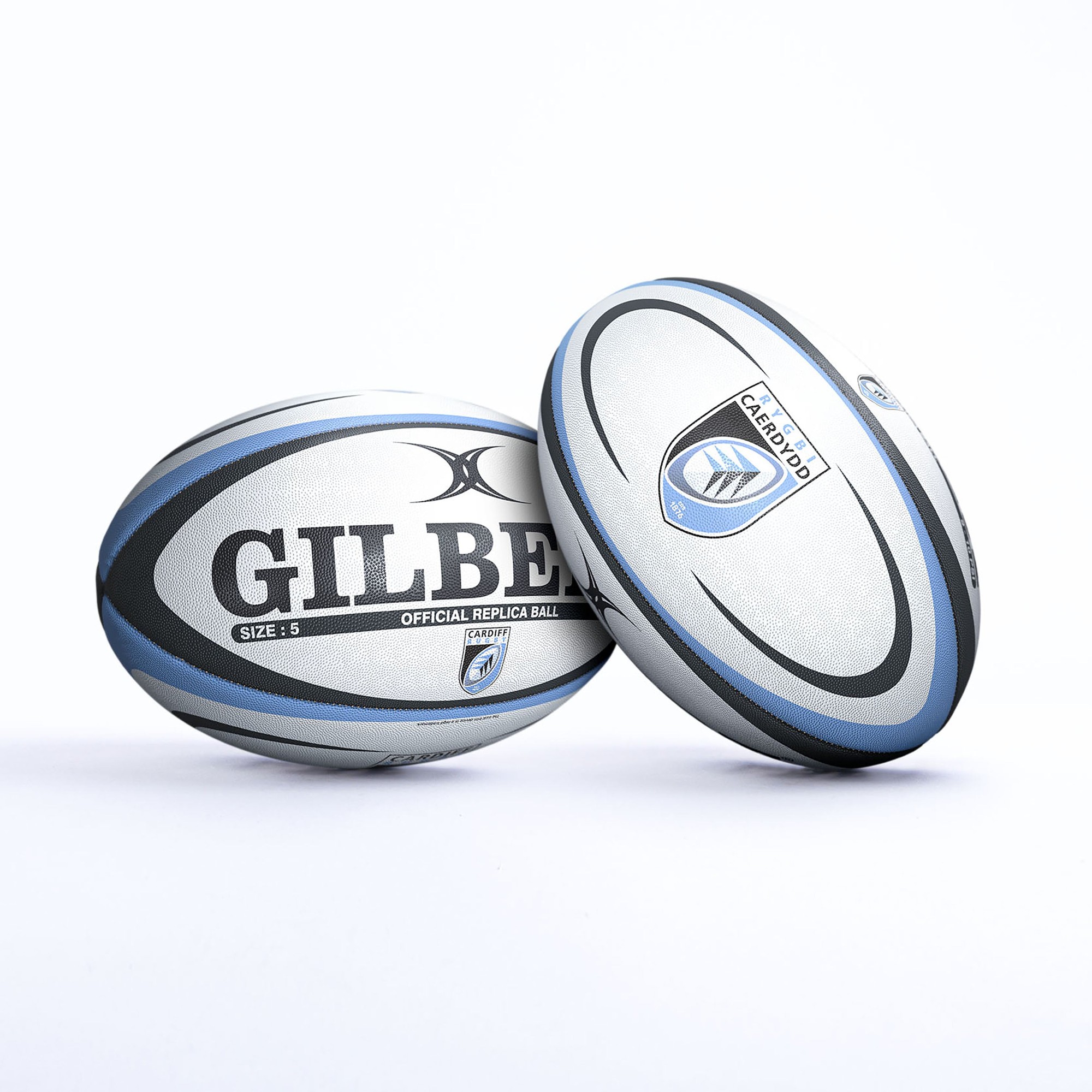 White and grey rugby ball featuring "GILBERT" logo, Cardiff emblem, and "SIZE 5" text, with a textured surface for grip and a classic oval shape.