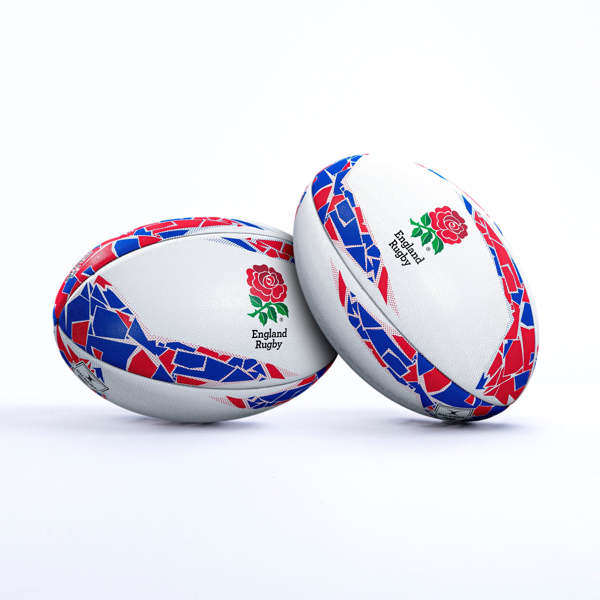 White rugby ball featuring red and blue geometric patterns, with the England Rugby rose logo prominently displayed on both sides.