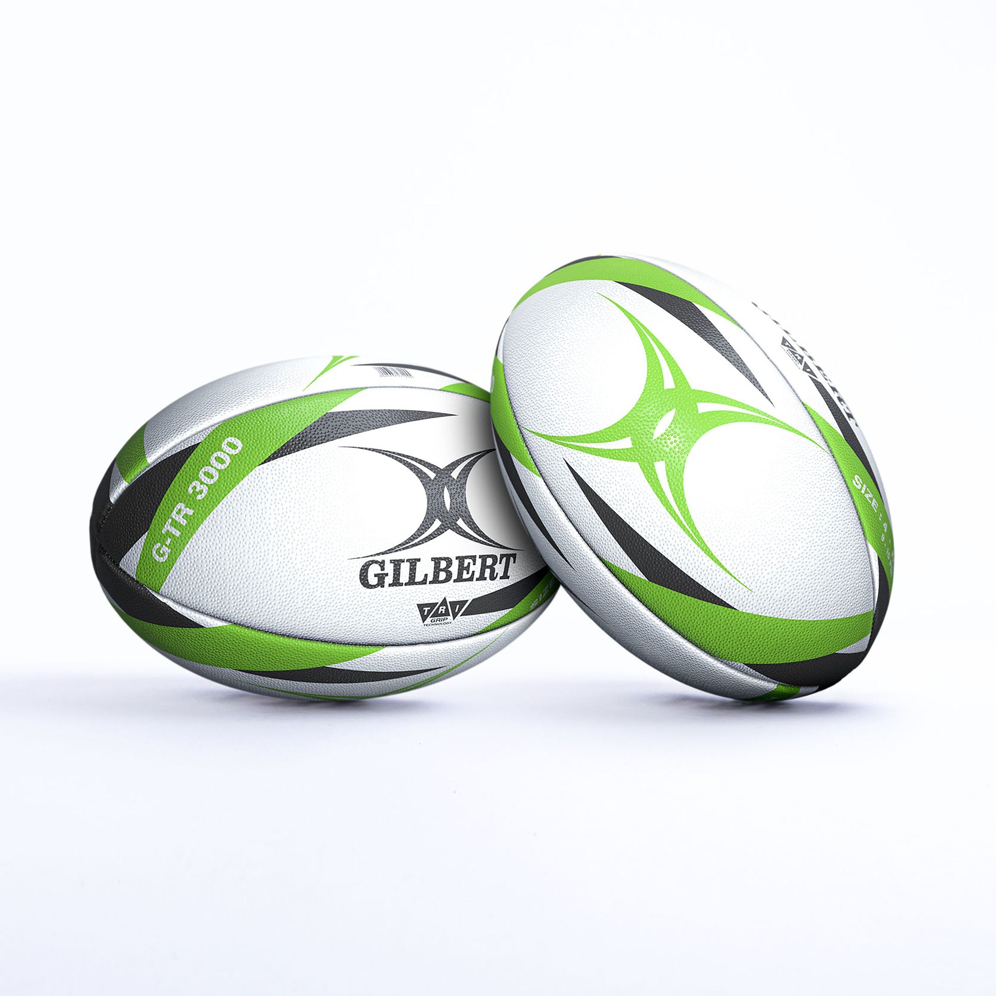 White rugby balls with black and vibrant green accents, featuring the "Gilbert" logo and "G-TR3000" branding, designed for training use.