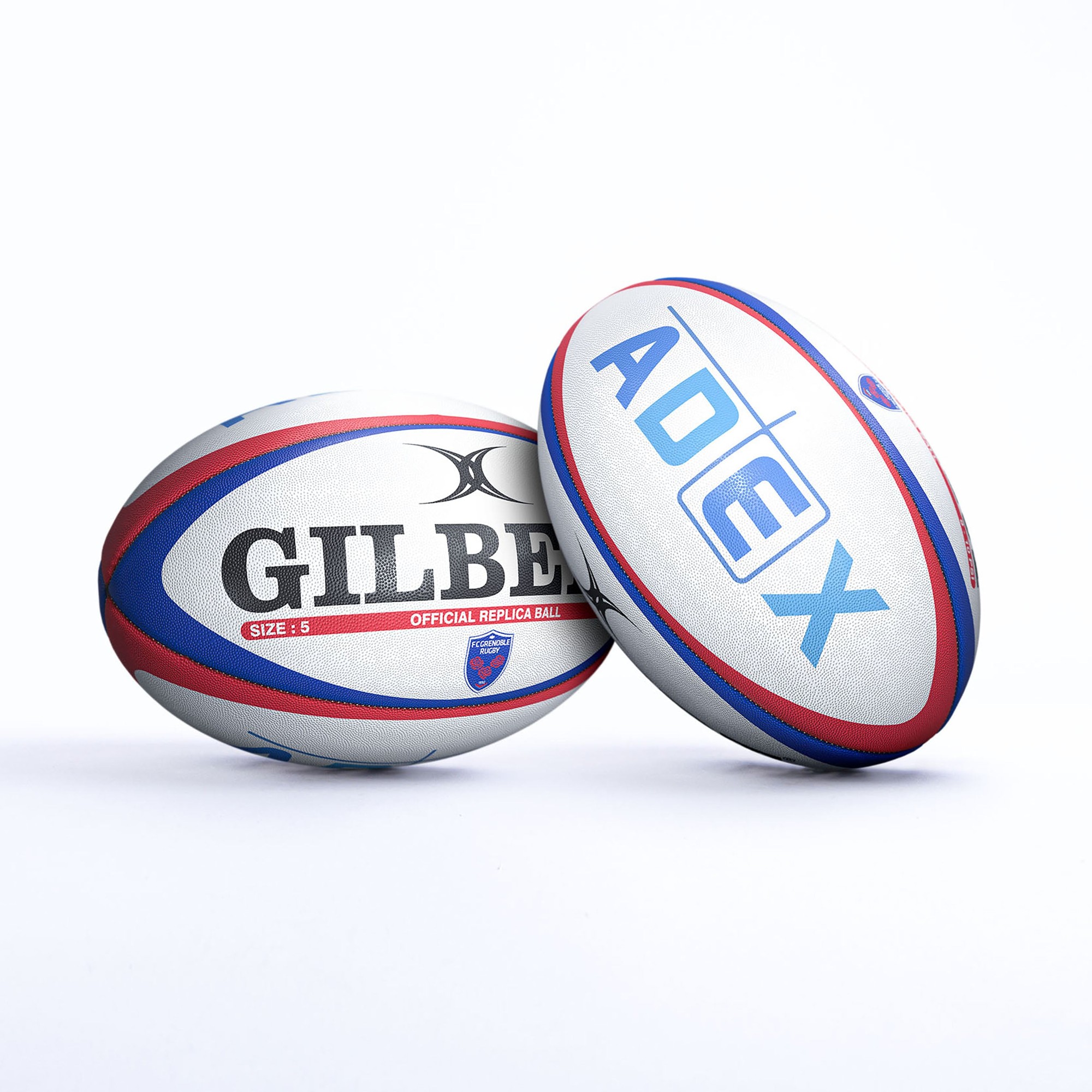Gilbert Grenoble Replica Rugby Ball in white, red, and blue, featuring the brand name "GILBERT" and "ADEX" logos, with a textured surface for grip and size 5 designation.