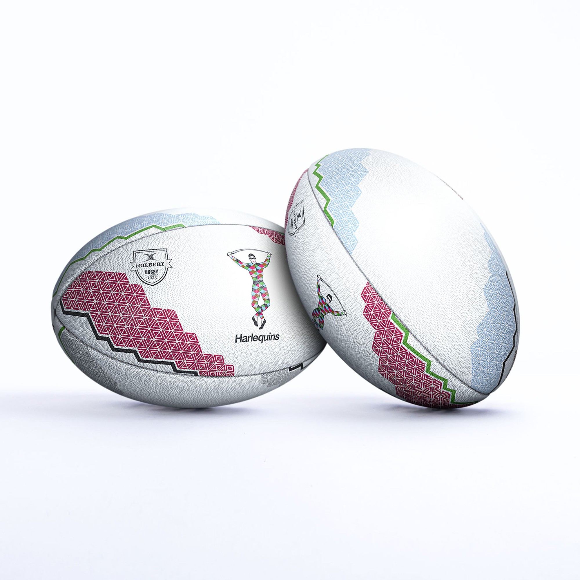 White rugby balls featuring a colorful geometric design in pink, green, and blue, with the Harlequins logo and textured surface for grip.