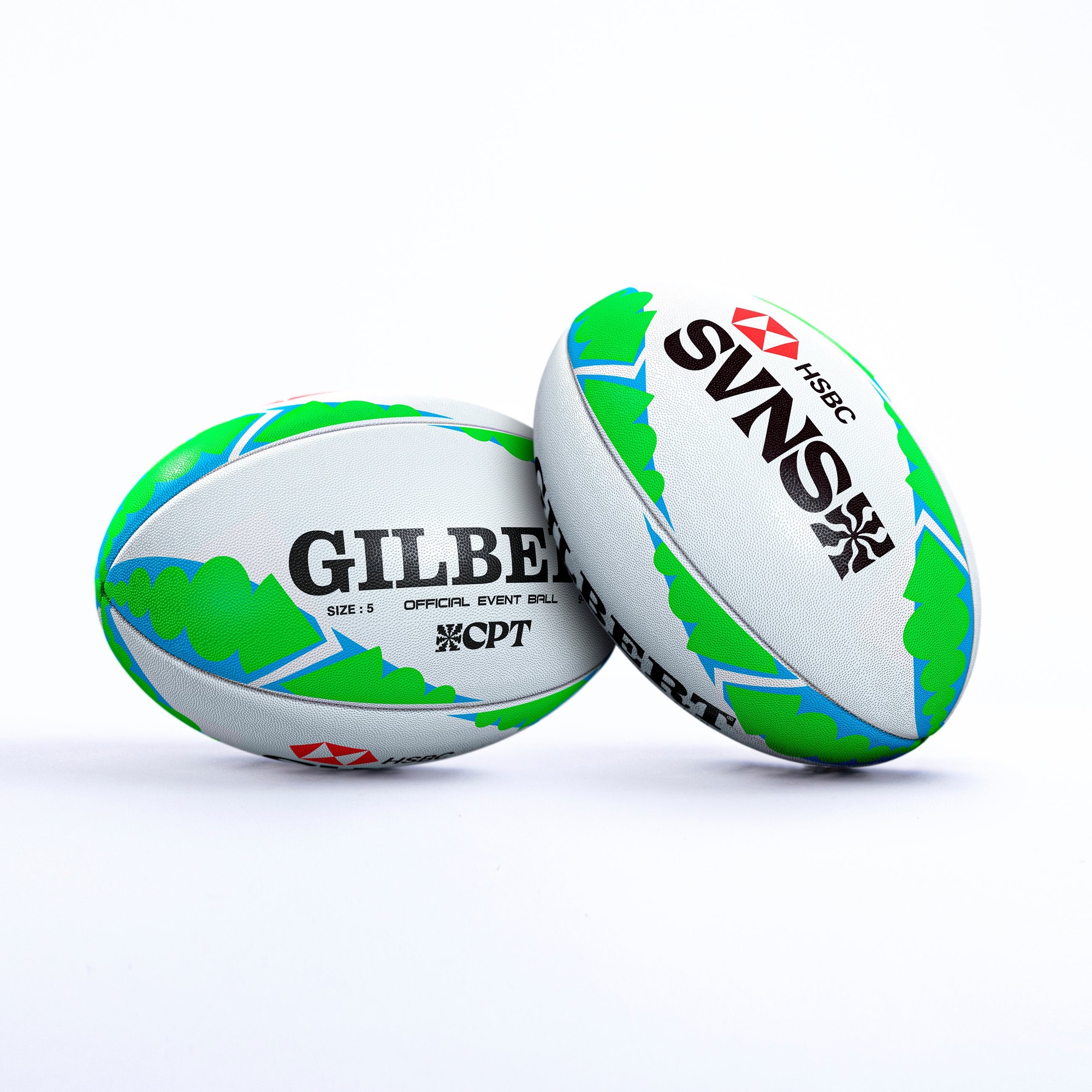 Two Gilbert Rugby balls featuring a white base with green and blue designs, labeled "GILBERT" and "SVNS" with HSBC branding, designed for the 2023/24 Cape Town event.