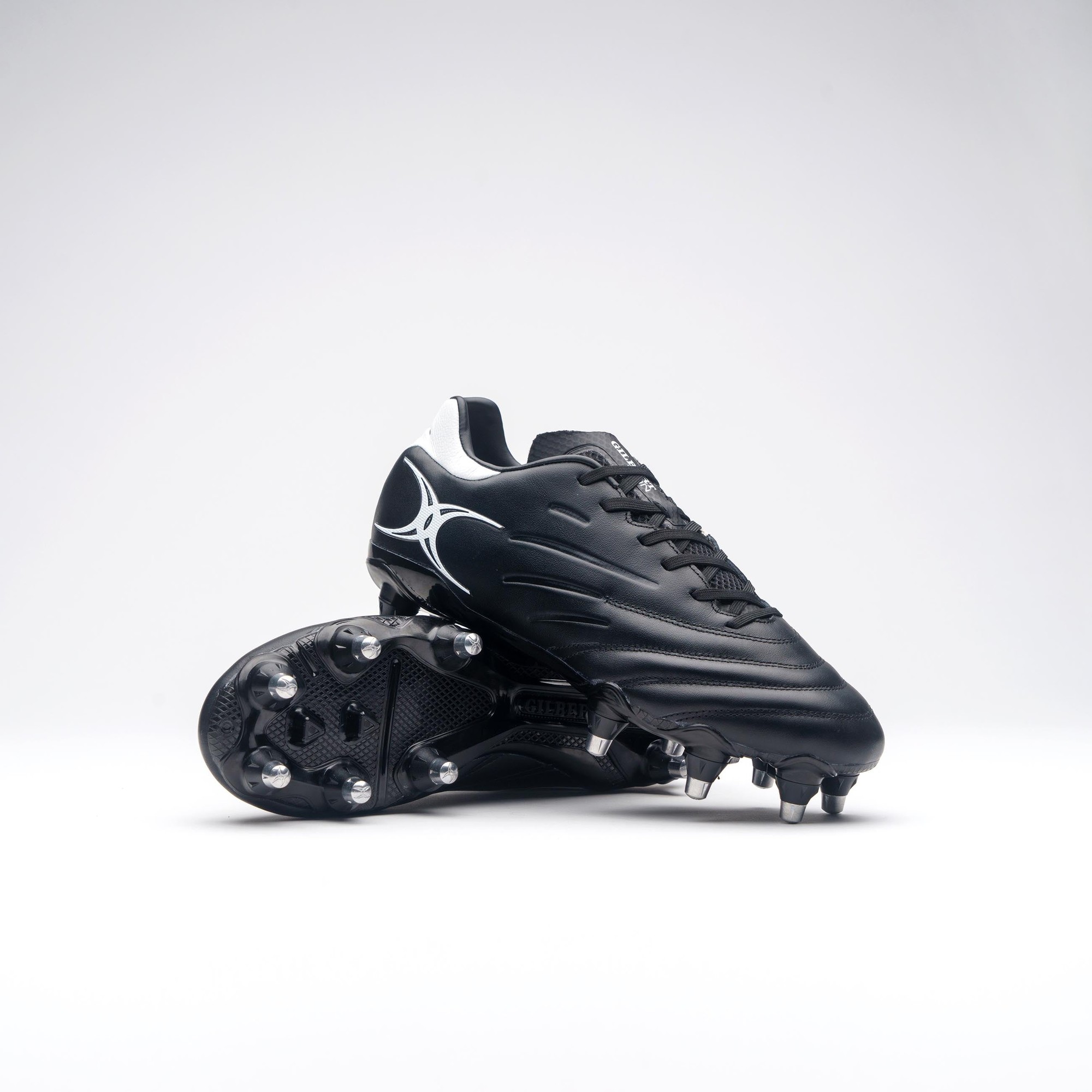 Black Gilbert Rugby Icon 8S boots feature a sleek design with a textured upper, silver detailing, and molded studs for traction on the field.