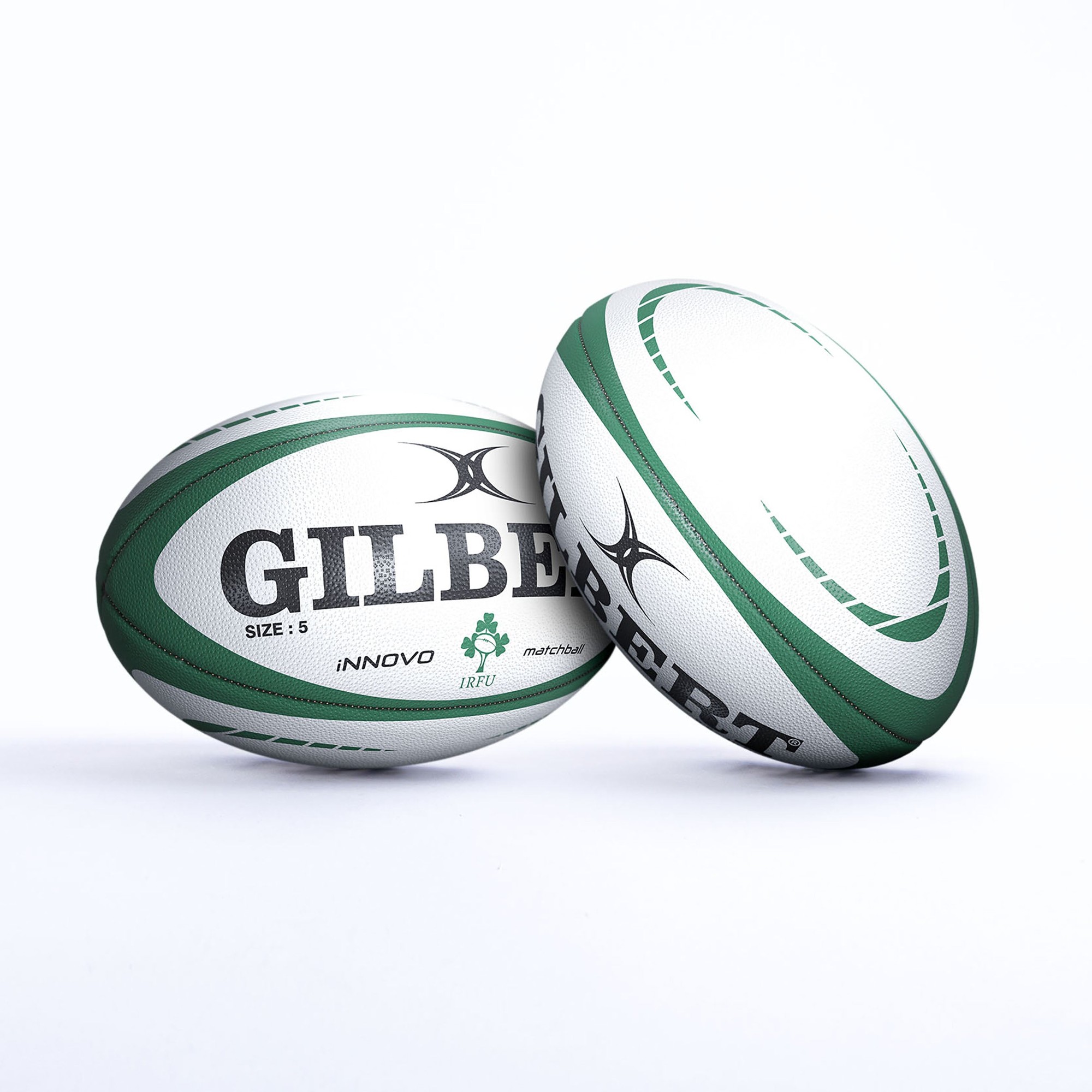 White rugby balls with green accents, featuring "GILBERT" prominently, labeled "SIZE 5" and "INNOVO," with the Irish Rugby Football Union logo.