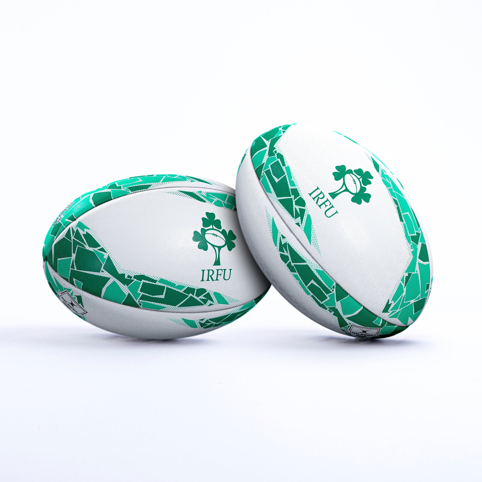 White rugby ball with green accents, featuring a shamrock logo and "IRFU" text, designed for Ireland supporters with a textured surface for grip.