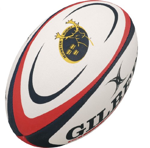 White rugby ball with red and navy accents, featuring the Munster Rugby logo and "Gilbert" branding, made of textured synthetic material for grip.