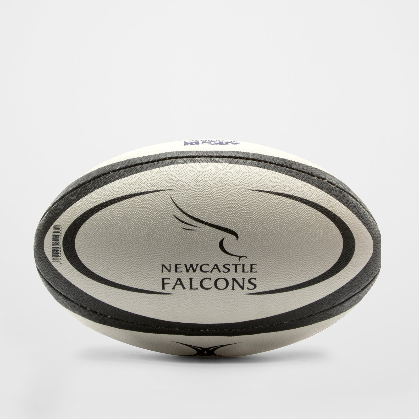 White rugby ball with black detailing, featuring the Newcastle Falcons logo and a textured surface for grip, designed for replica play by Gilbert Rugby.