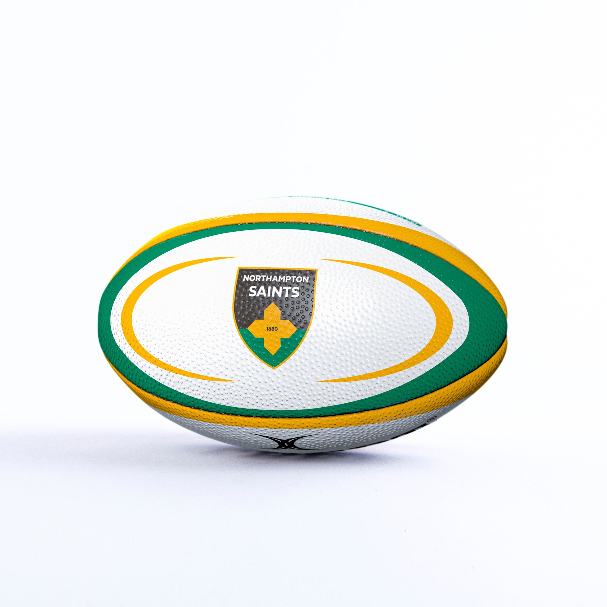 White rugby ball featuring green and yellow accents, embossed texture, and the Northampton Saints logo prominently displayed on one side.