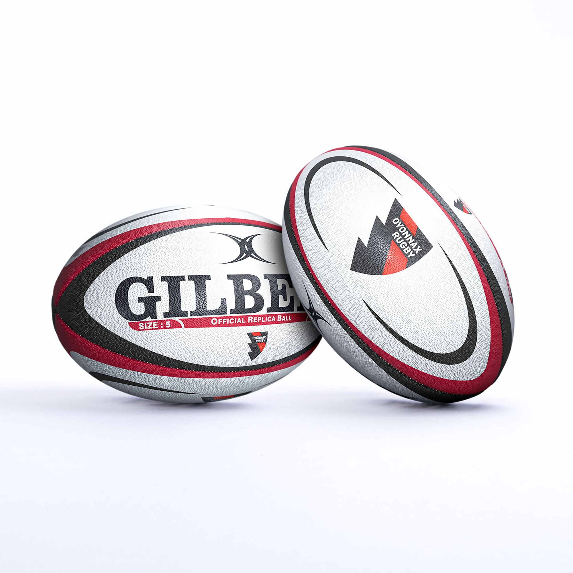 White rugby ball with red and black accents, featuring "GILBERT" and "OFFICIAL REPLICA BALL" text, and the Oyonnax logo, designed for size 5 play.