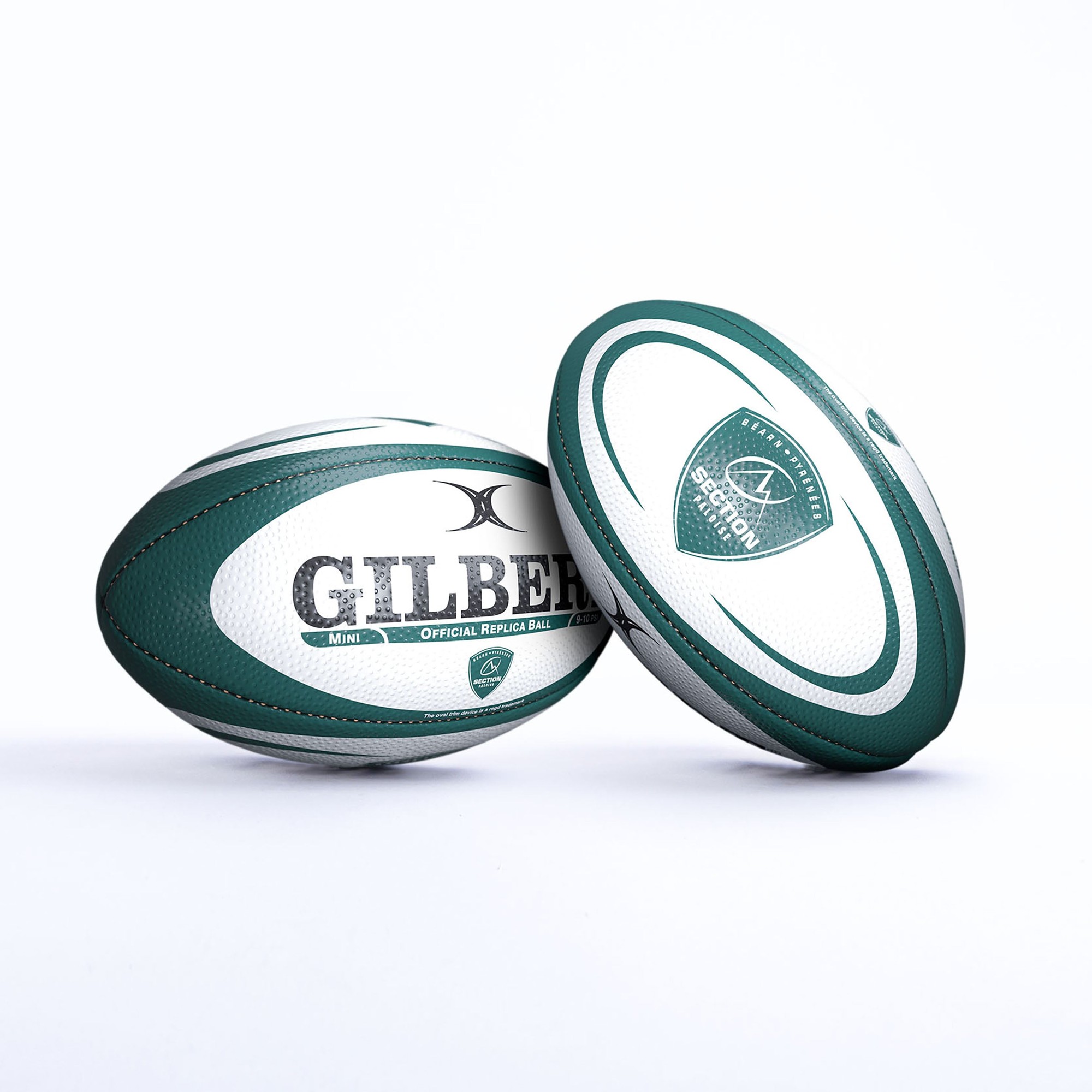 Green and white Gilbert Pau replica rugby ball featuring textured surface, prominent "GILBERT" branding, and official replica markings, ideal for mini games or display.