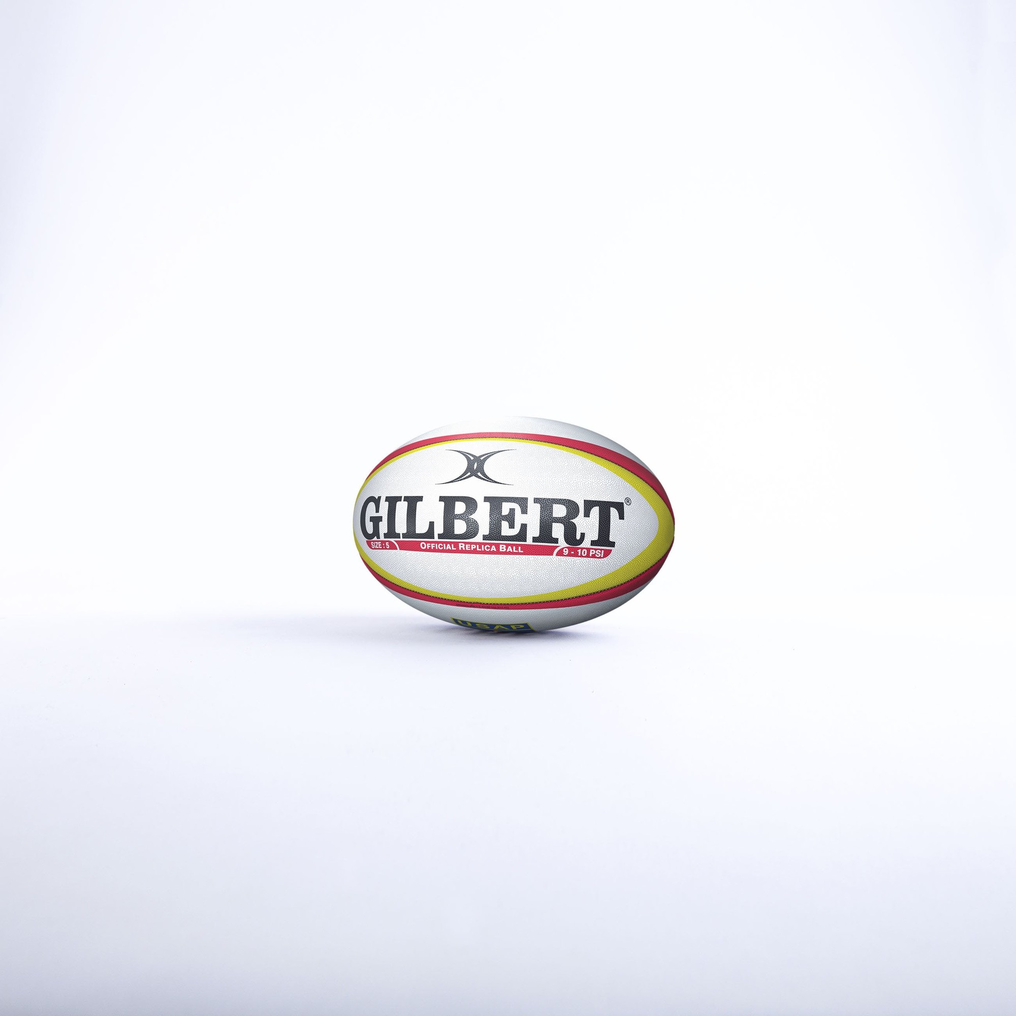 The "Balloon Perpignan" rugby ball by Gilbert features a white and yellow design with red accents, prominently displaying the "GILBERT" logo in bold black lettering.