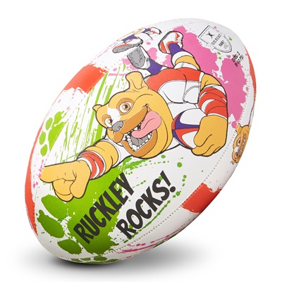 A colorful rugby ball featuring a cartoon dog mascot, Ruckley, with vibrant green and pink splashes, and the text "RUCKLEY ROCKS!" printed on its surface.