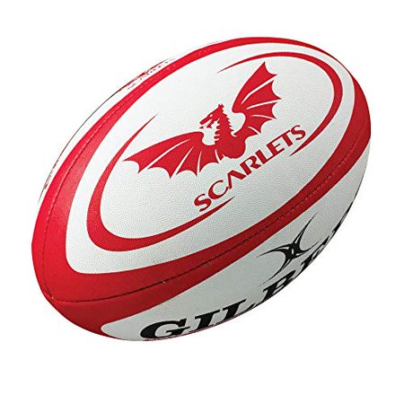 Red and white Gilbert Scarlets replica rugby ball featuring a dragon logo, textured surface, and bold "GILBERT" branding on the side.