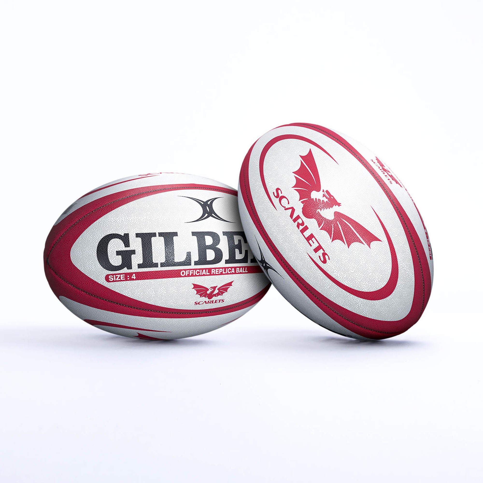 Red and white Gilbert Scarlets replica rugby ball featuring a bat logo, textured surface, and "GILBERT" branding, designed for size 4 play.