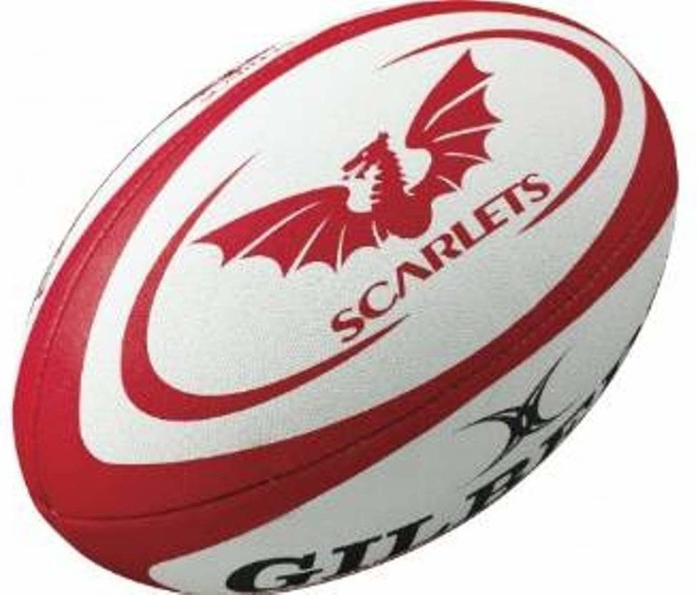 Red and white Gilbert Scarlets replica rugby ball featuring a dragon logo, textured surface, and the brand name "GILBERT" prominently displayed.