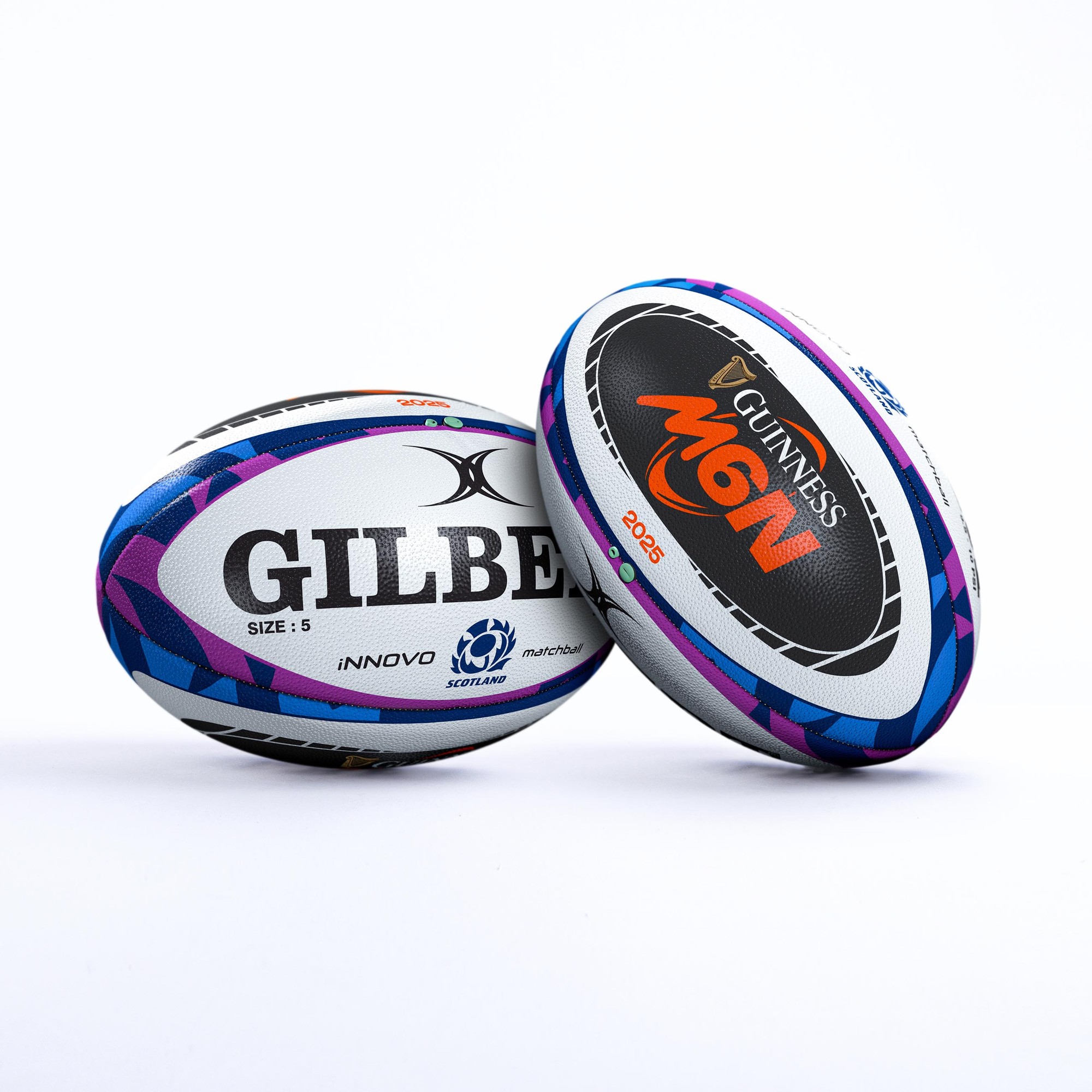 Two rugby balls featuring the Gilbert logo, one in white with blue and purple accents, and the other in black with orange, both labeled for the Guinness Six Nations 2025.