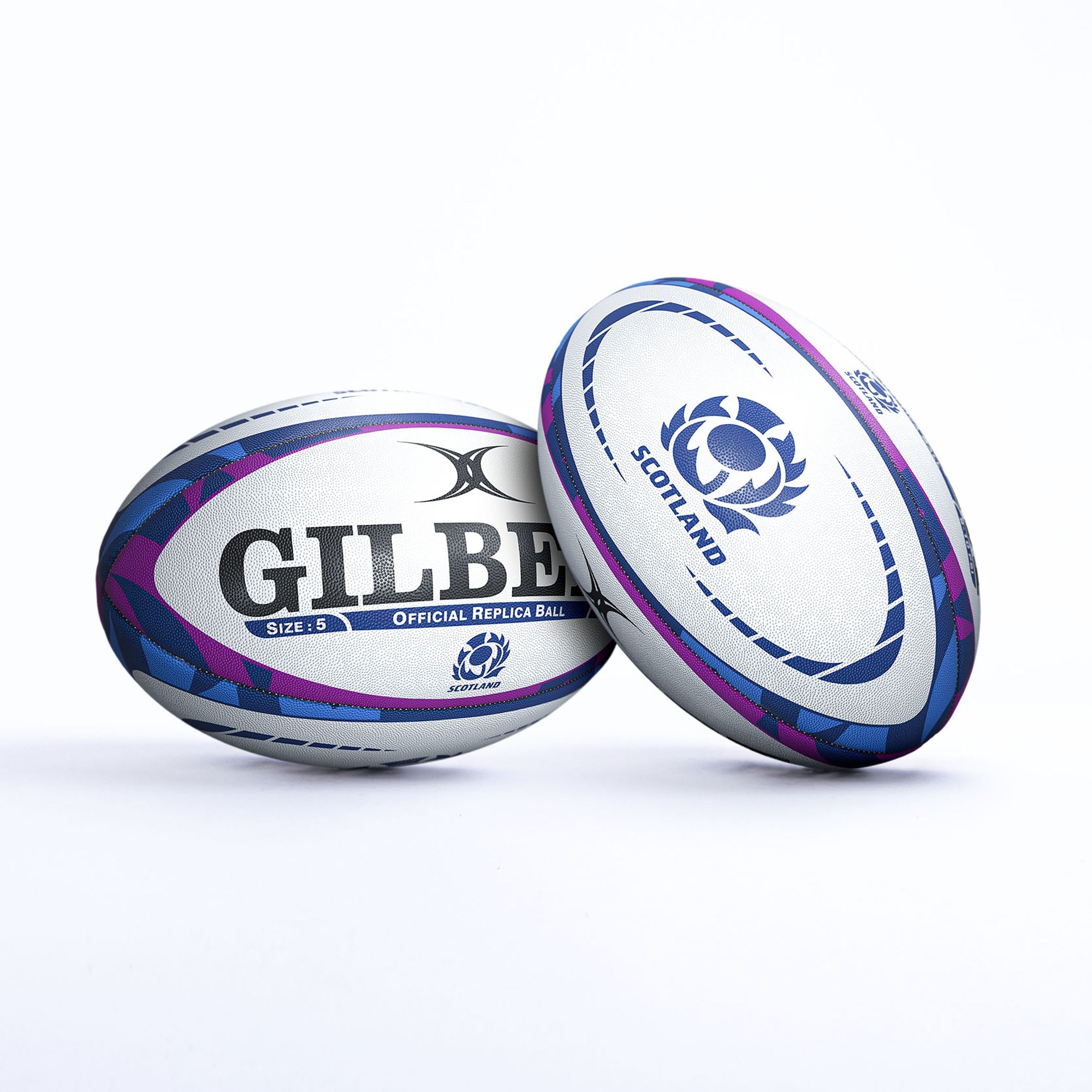 Gilbert Scotland replica rugby ball in white with purple and blue accents, featuring "GILBERT" and "OFFICIAL REPLICA BALL" text, and Scotland's emblem. Size 5.