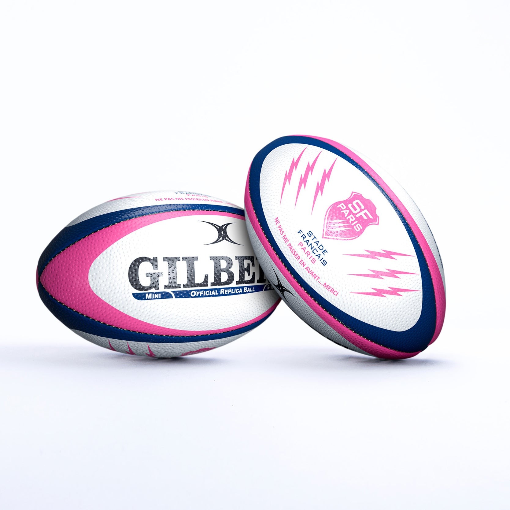 Stade Francais replica rugby ball featuring a white, pink, and navy design with the Gilbert logo and lightning bolt graphics, made from durable synthetic material.